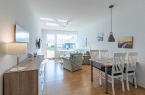 Wohnzimmer mit Zugang zum Balkon mit seitlichem Blick auf die Nordsee